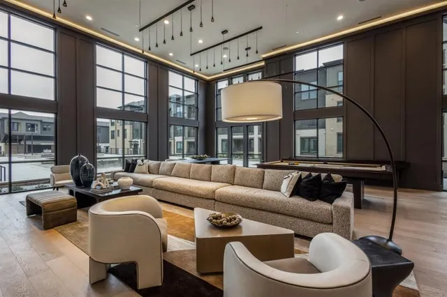 a dining room with furniture a chandelier and wooden floor