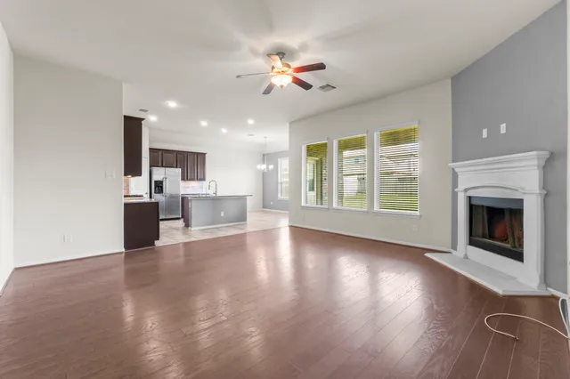 a view of a living room a kitchen and a fireplace