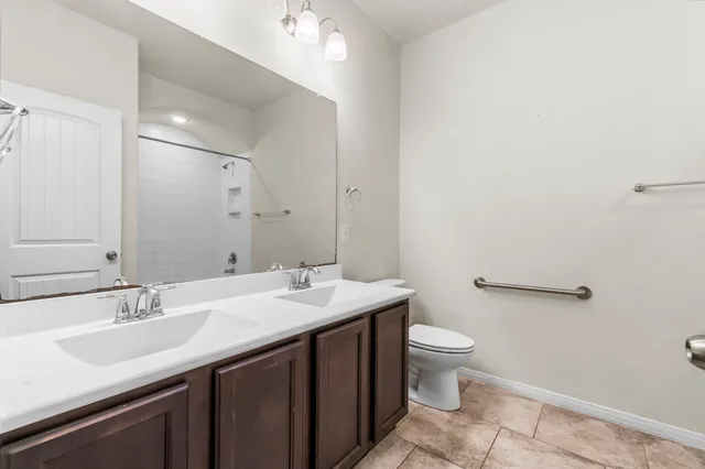 a bathroom with a sink toilet and a mirror