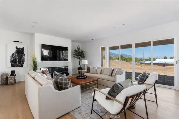 a living room with furniture and a table with wooden floor