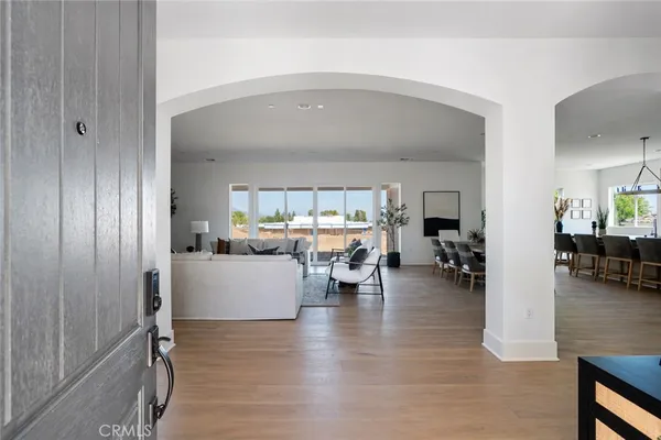 a living room with furniture and a floor to ceiling window