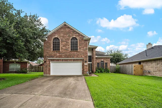 a front view of house with yard and garage