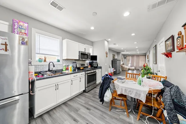 a very nice looking room with wooden floor and furniture