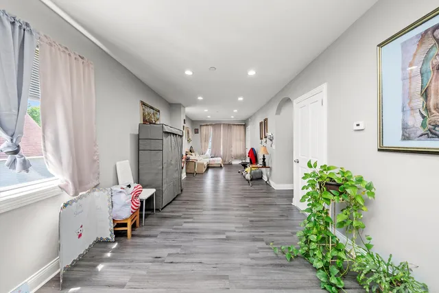 a living room with furniture and a hallway