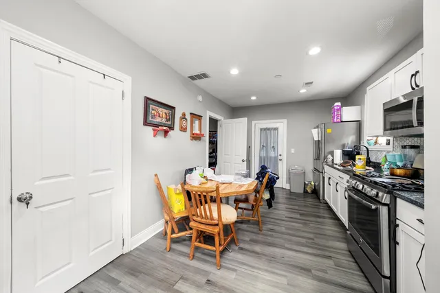 a view of a dining room with furniture wooden floor and windows