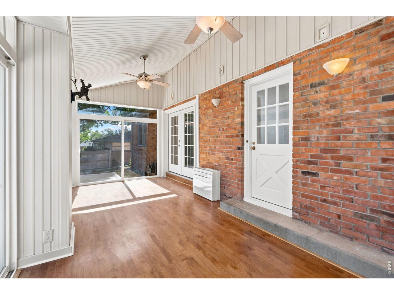 2121 18th Street Road Greeley, CO 80631 - Photo 12 of 40 The enclosed sun room is surrounded by sliding doors that take you to the oversized deck. Perfect for entertaining out the french doors from the kitchen.