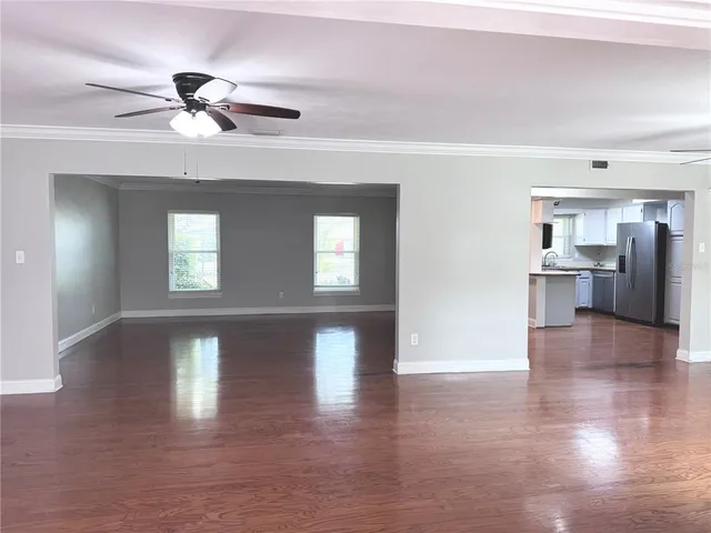 a view of a kitchen with a sink stainless steel appliances and wooden floor