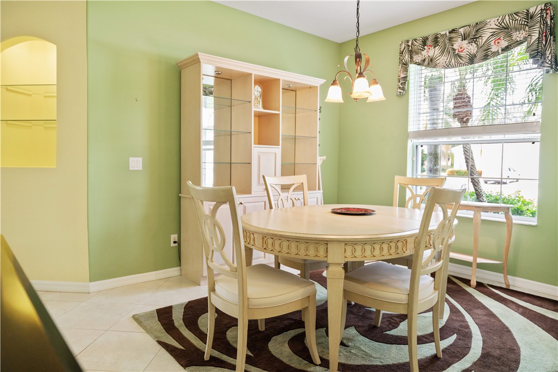 412 North Tangerine Square Southwest Vero Beach, FL 32968 - Photo 11 of 35 a dining room with furniture and window