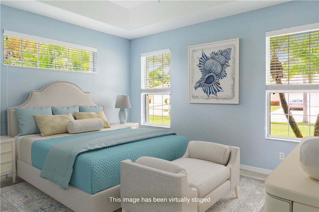 412 North Tangerine Square Southwest Vero Beach, FL 32968 - Photo 12 of 35 a bedroom with a bed and a couch