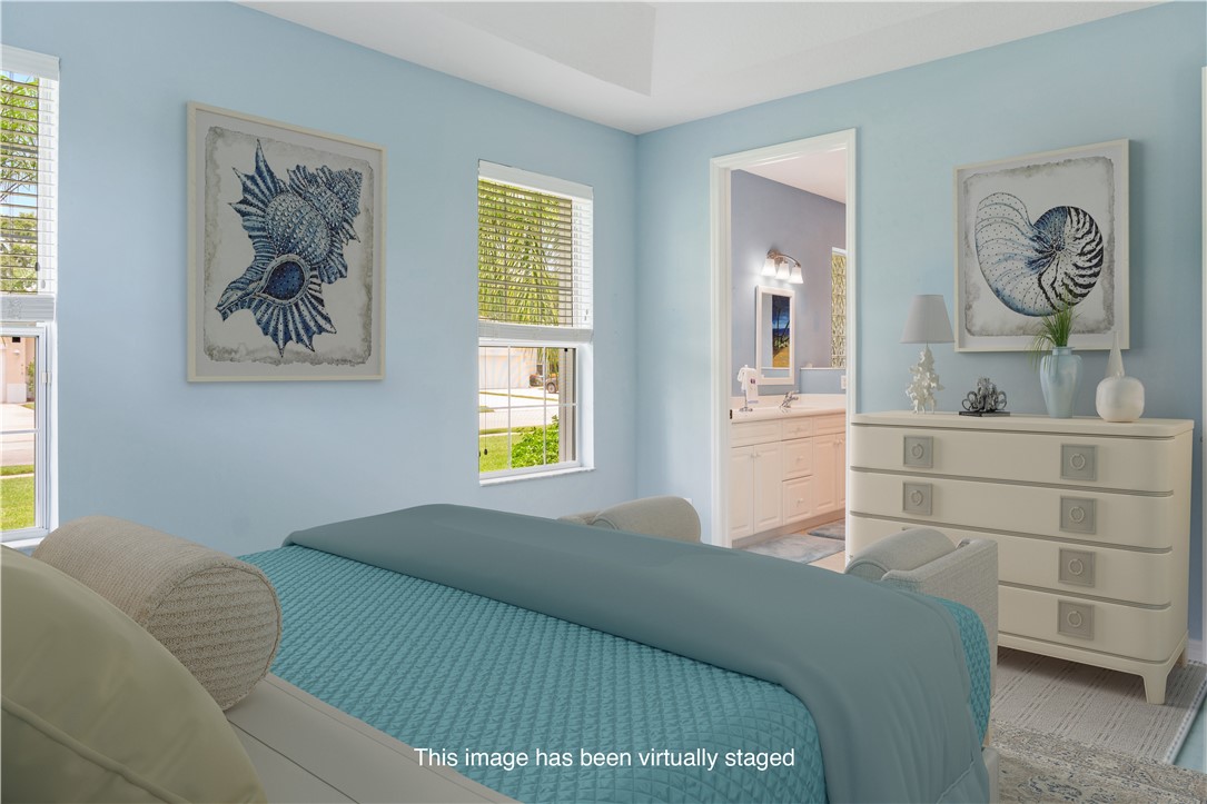 412 North Tangerine Square Southwest Vero Beach, FL 32968 - Photo 13 of 35 a bedroom with a bed and a window