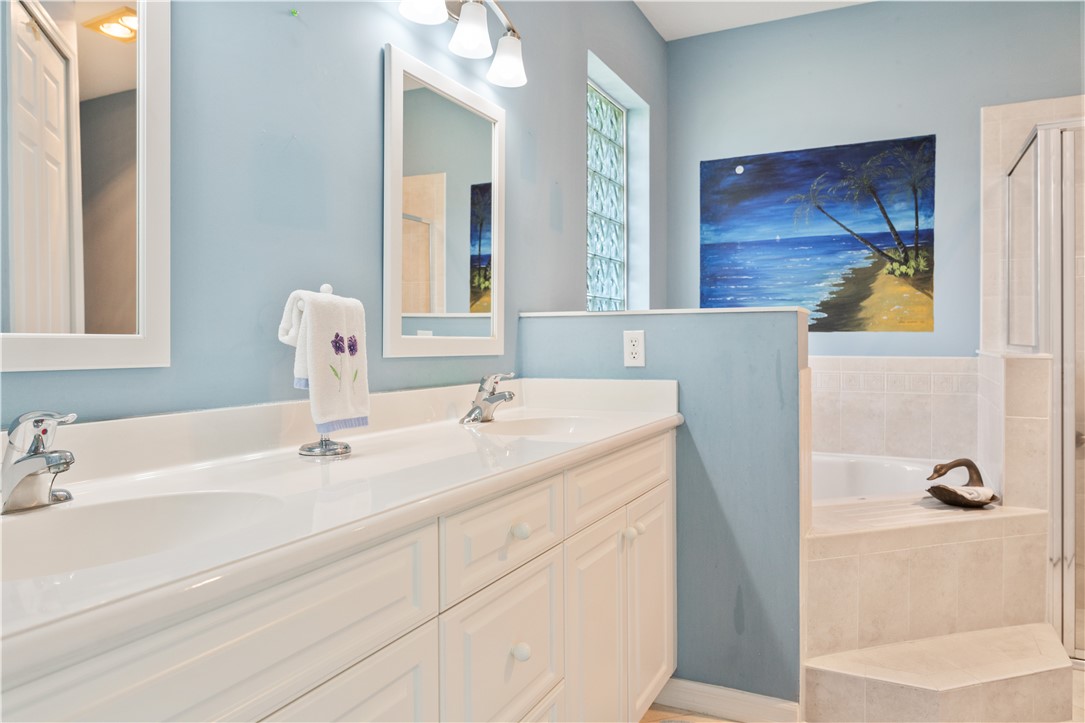 412 North Tangerine Square Southwest Vero Beach, FL 32968 - Photo 14 of 35 a bathroom with a sink and a mirror