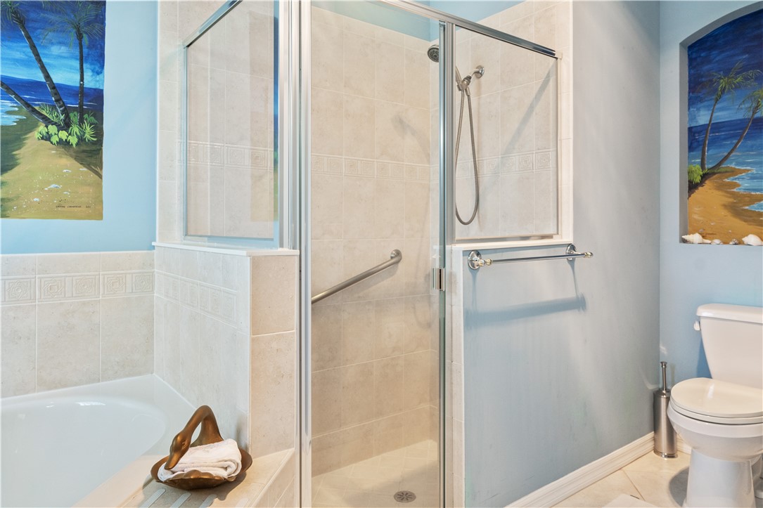 412 North Tangerine Square Southwest Vero Beach, FL 32968 - Photo 15 of 35 a bathroom with a shower and a toilet