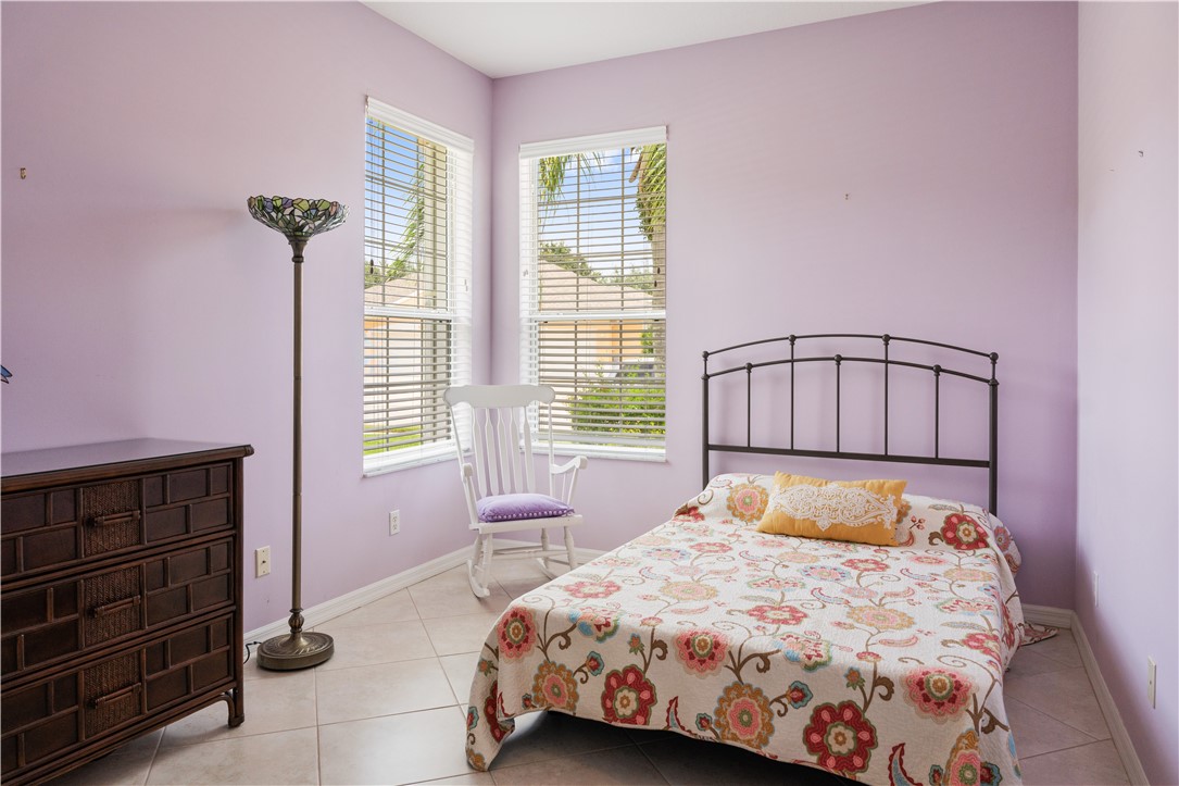 412 North Tangerine Square Southwest Vero Beach, FL 32968 - Photo 17 of 35 a bedroom with a bed and a window