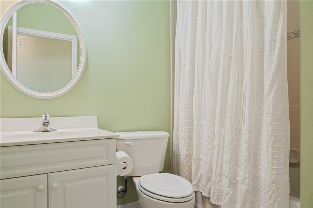 412 North Tangerine Square Southwest Vero Beach, FL 32968 - Photo 19 of 35 a bathroom with a sink a toilet and a mirror