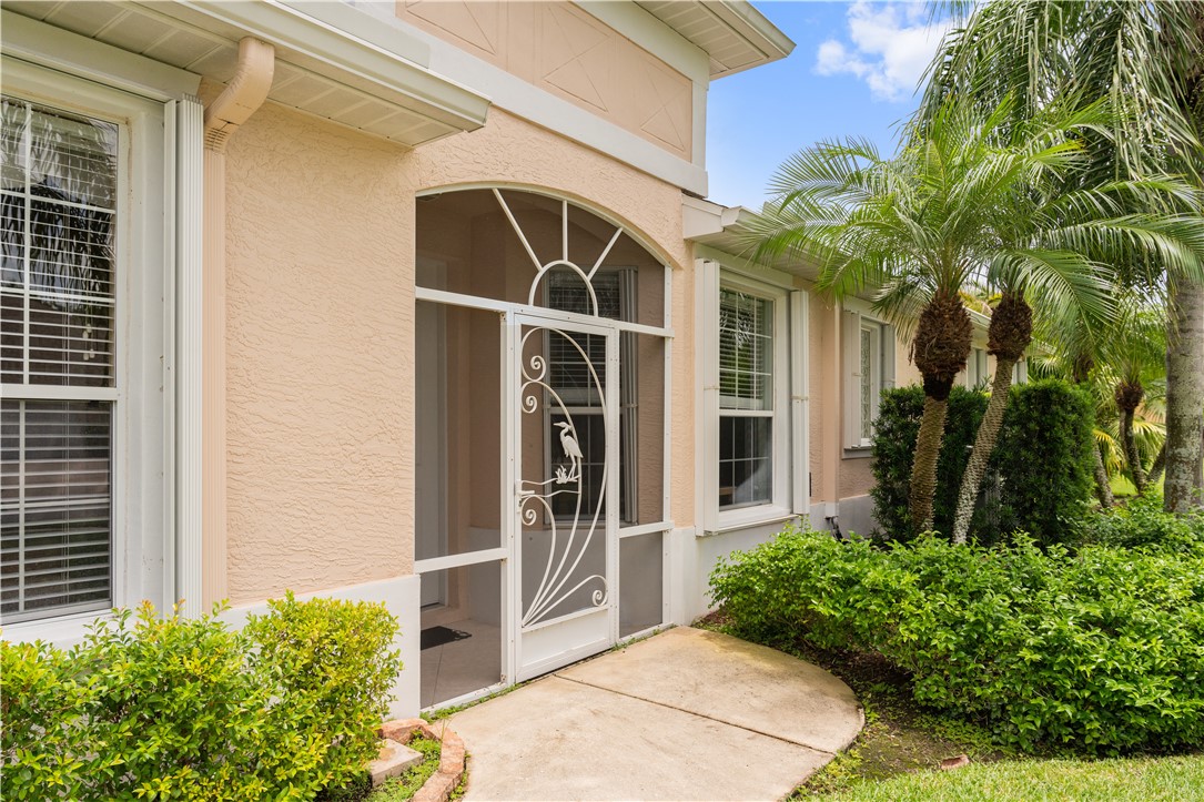 412 North Tangerine Square Southwest Vero Beach, FL 32968 - Photo 2 of 35 a front view of a house with a yard