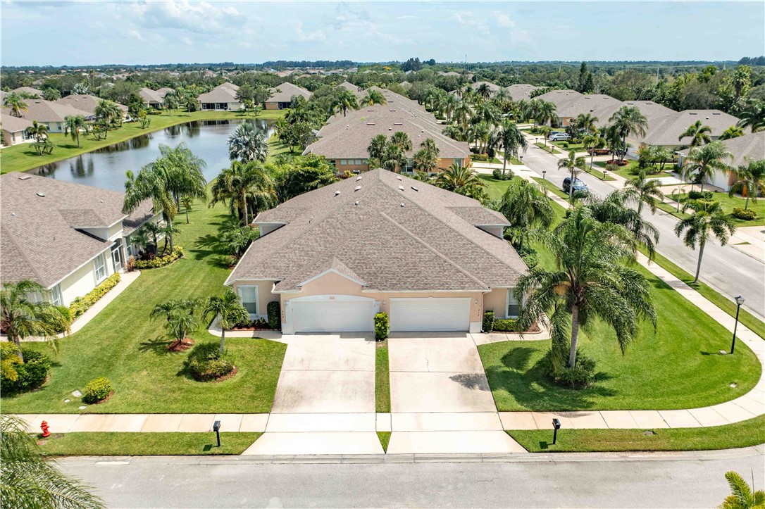 412 North Tangerine Square Southwest Vero Beach, FL 32968 - Photo 25 of 35 an aerial view of a house with a yard and lake