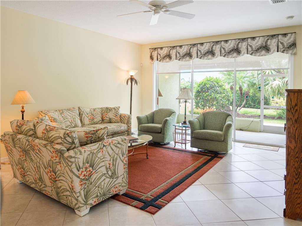 412 North Tangerine Square Southwest Vero Beach, FL 32968 - Photo 3 of 35 a living room with furniture and a large window