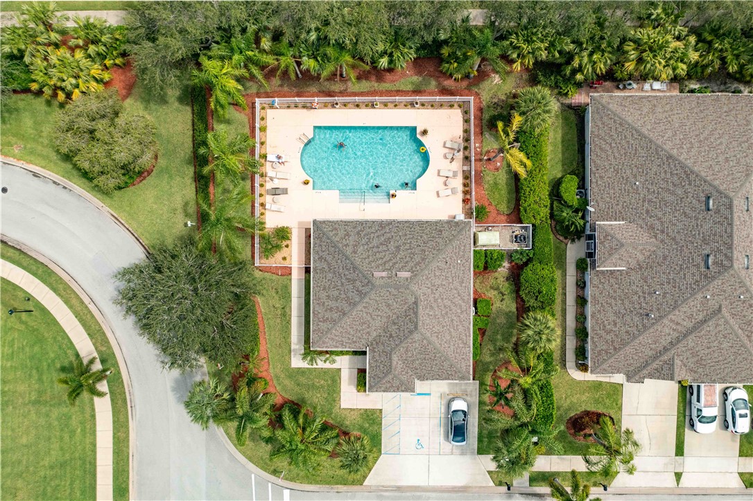 412 North Tangerine Square Southwest Vero Beach, FL 32968 - Photo 31 of 35 an aerial view of a house with a yard fountain and large tree