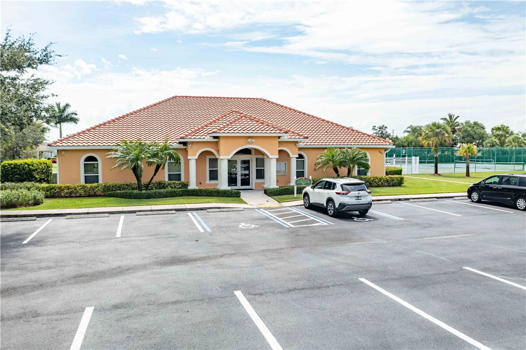412 North Tangerine Square Southwest Vero Beach, FL 32968 - Photo 33 of 35 a view of a parked cars in front of house