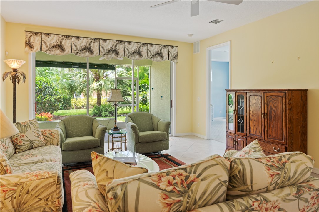 412 North Tangerine Square Southwest Vero Beach, FL 32968 - Photo 6 of 35 a bedroom with furniture and a large window