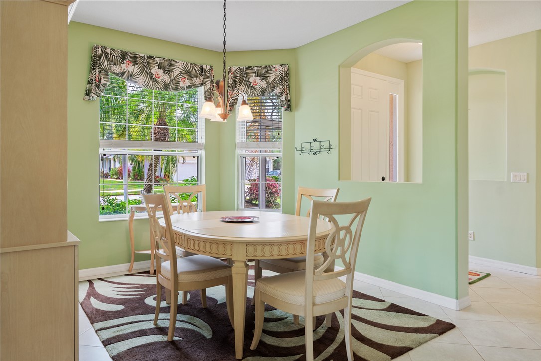 412 North Tangerine Square Southwest Vero Beach, FL 32968 - Photo 10 of 35 a dining room with furniture a chandelier and window