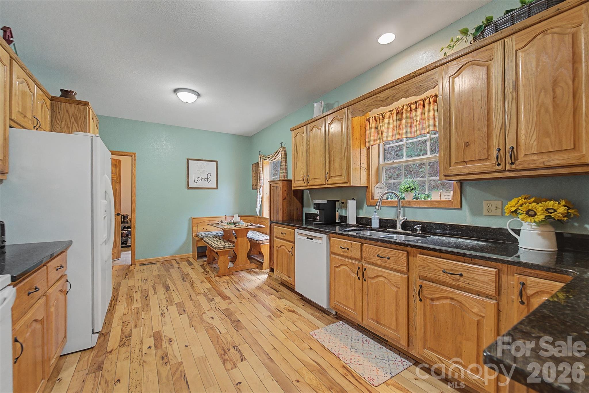 1960 Atoah Road Robbinsville, NC 28771 - Photo 15 of 48 a kitchen with stainless steel appliances granite countertop a stove a sink dishwasher and a refrigerator with wooden cabinets