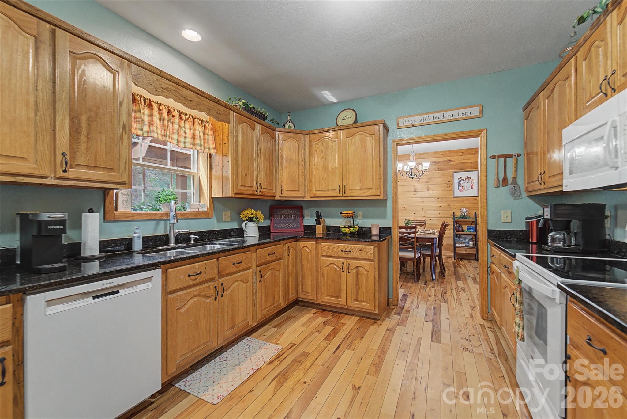 1960 Atoah Road Robbinsville, NC 28771 - Photo 17 of 48 a kitchen with stainless steel appliances granite countertop sink stove top oven and cabinets