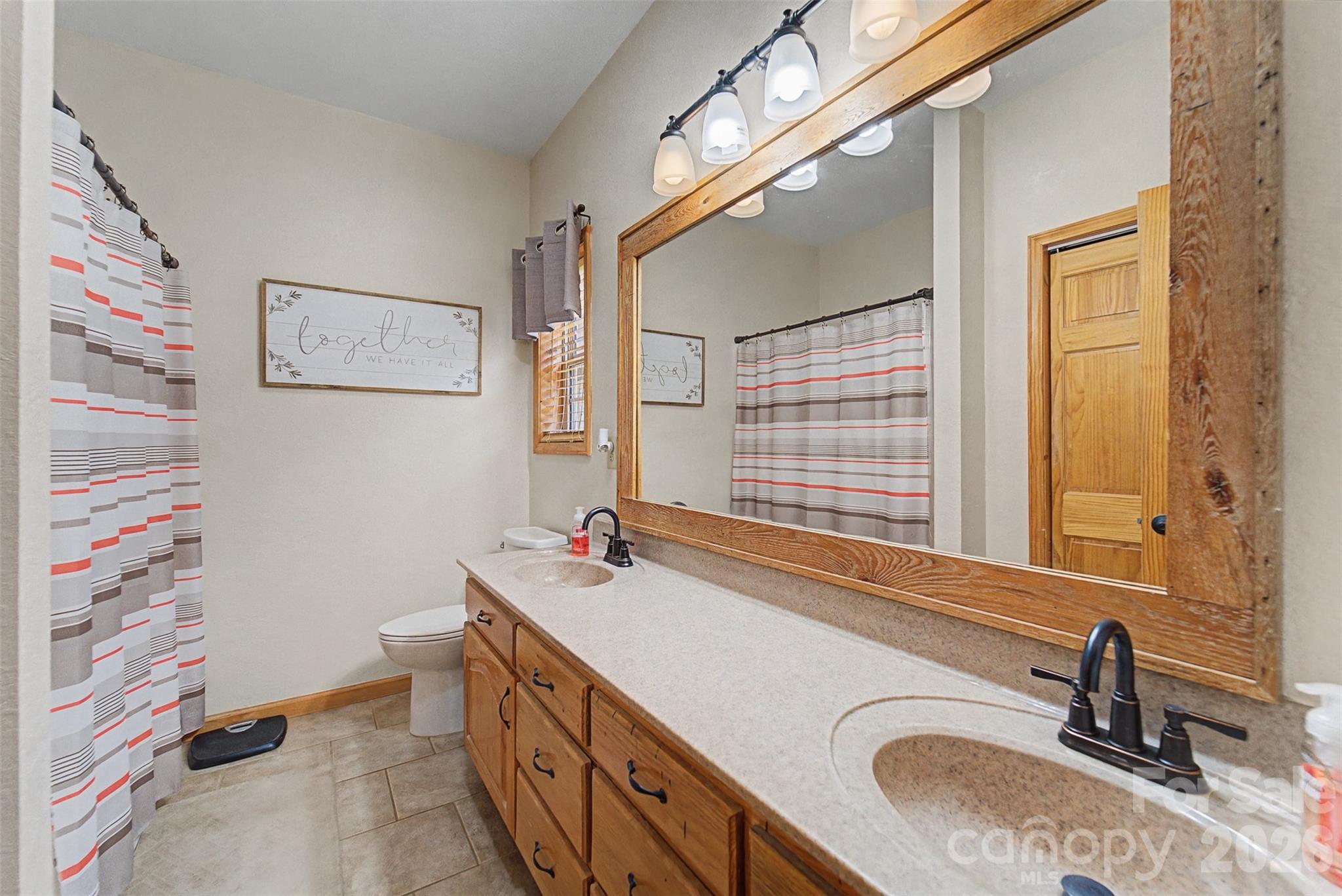 1960 Atoah Road Robbinsville, NC 28771 - Photo 24 of 48 a bathroom with a sink double vanity and a shower