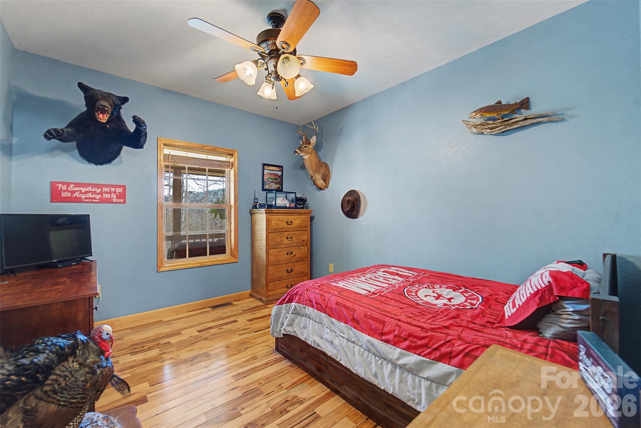 1960 Atoah Road Robbinsville, NC 28771 - Photo 25 of 48 a bedroom with a bed and a chandelier