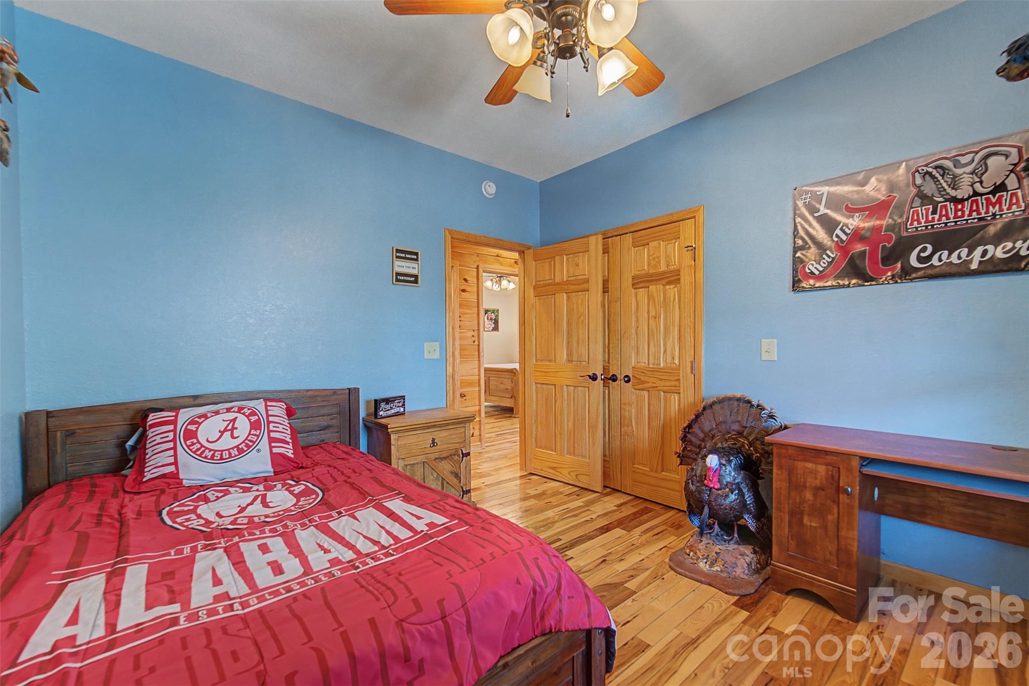 1960 Atoah Road Robbinsville, NC 28771 - Photo 26 of 48 a bedroom with a bed and a chandelier