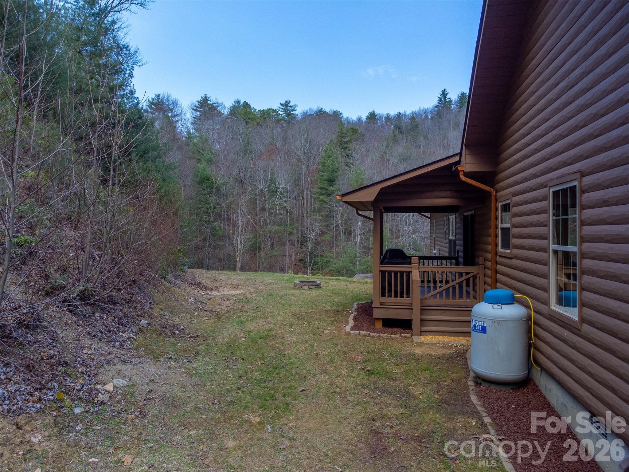1960 Atoah Road Robbinsville, NC 28771 - Photo 39 of 48 a view of a chair and tables in the backyard of the house