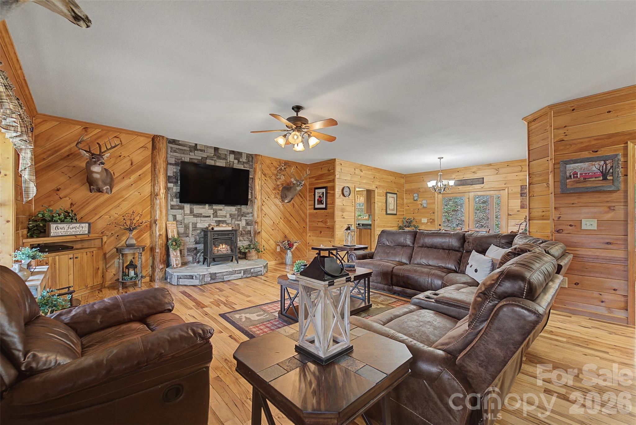 1960 Atoah Road Robbinsville, NC 28771 - Photo 8 of 48 a living room with furniture a flat screen tv and a fireplace