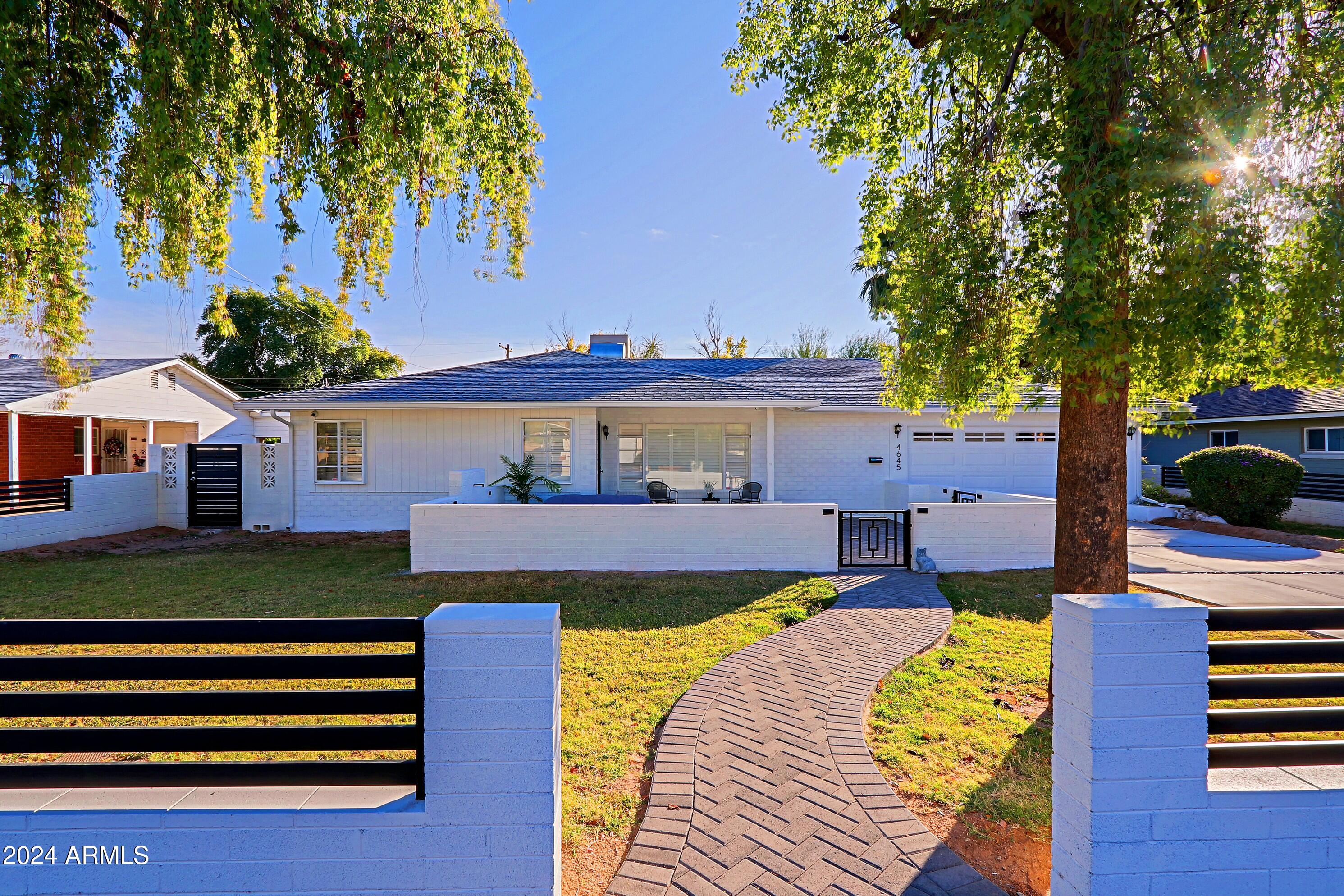 4645 East Windsor Avenue Phoenix, AZ 85008 - Photo 1 of 33 a front view of a house with a garden and yard