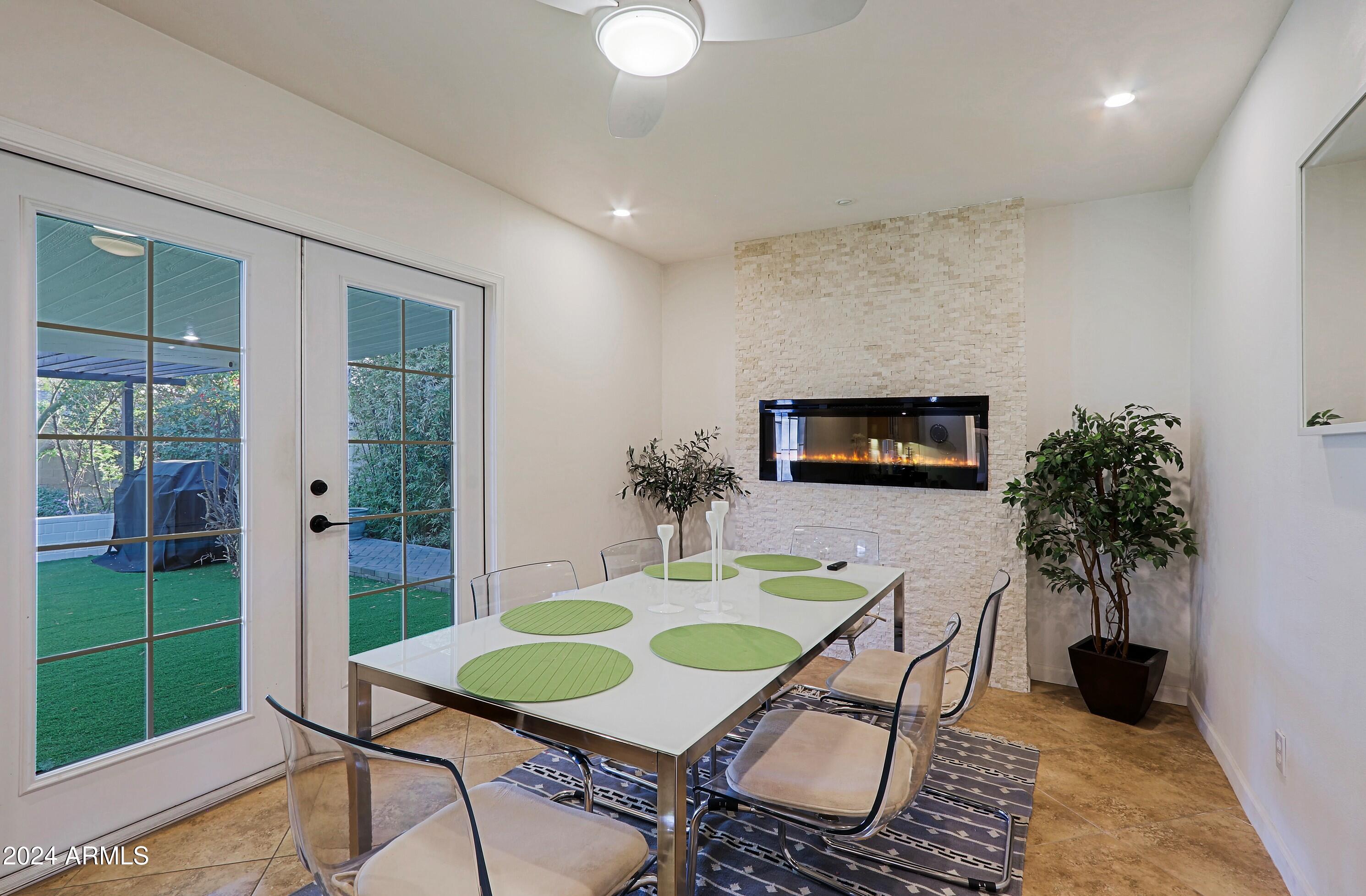 4645 East Windsor Avenue Phoenix, AZ 85008 - Photo 13 of 33 a dining room with furniture and a floor to ceiling window