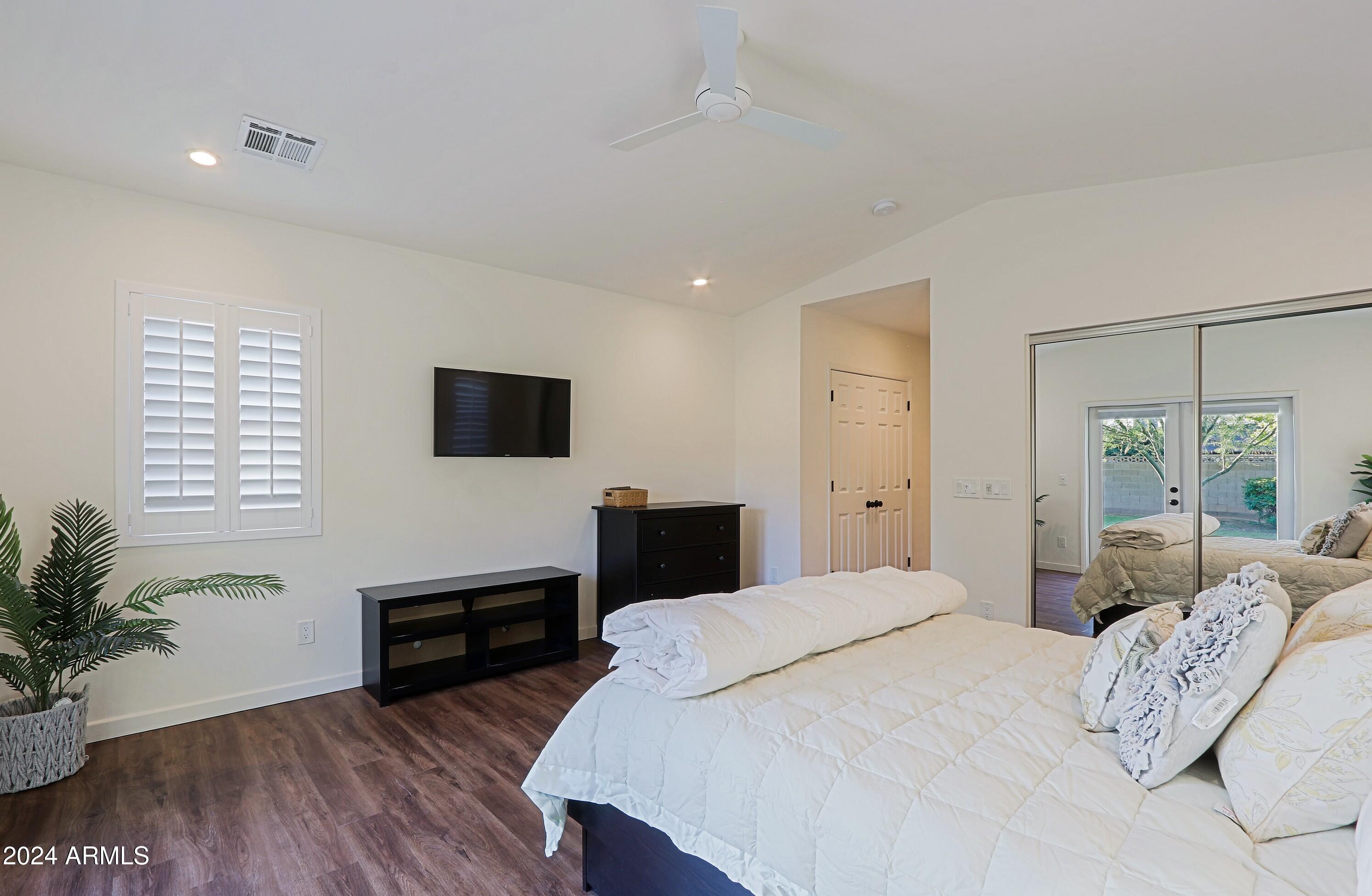 4645 East Windsor Avenue Phoenix, AZ 85008 - Photo 17 of 33 a bedroom with a bed and a flat screen tv