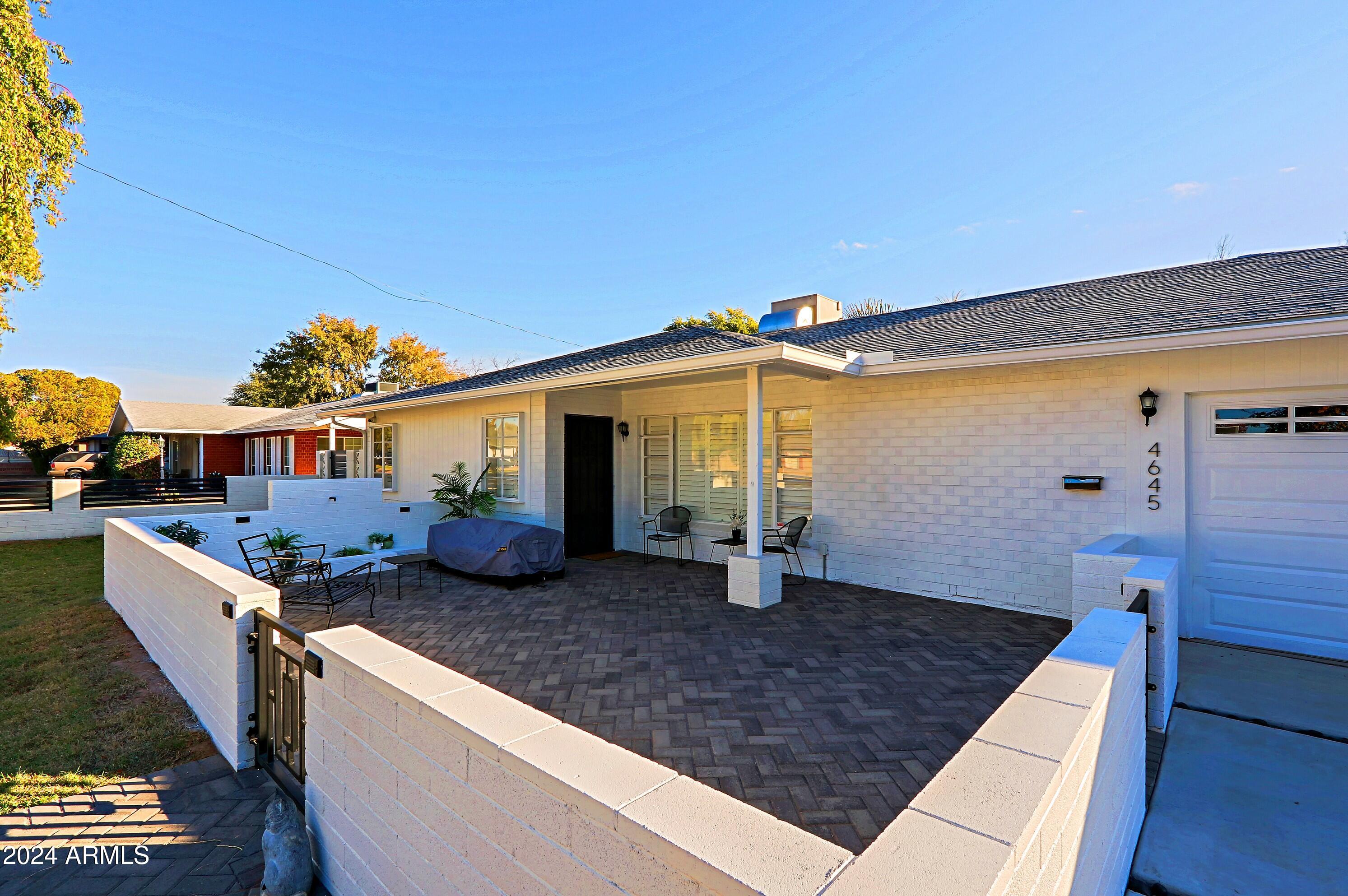 4645 East Windsor Avenue Phoenix, AZ 85008 - Photo 2 of 33 a front view of a house with garden