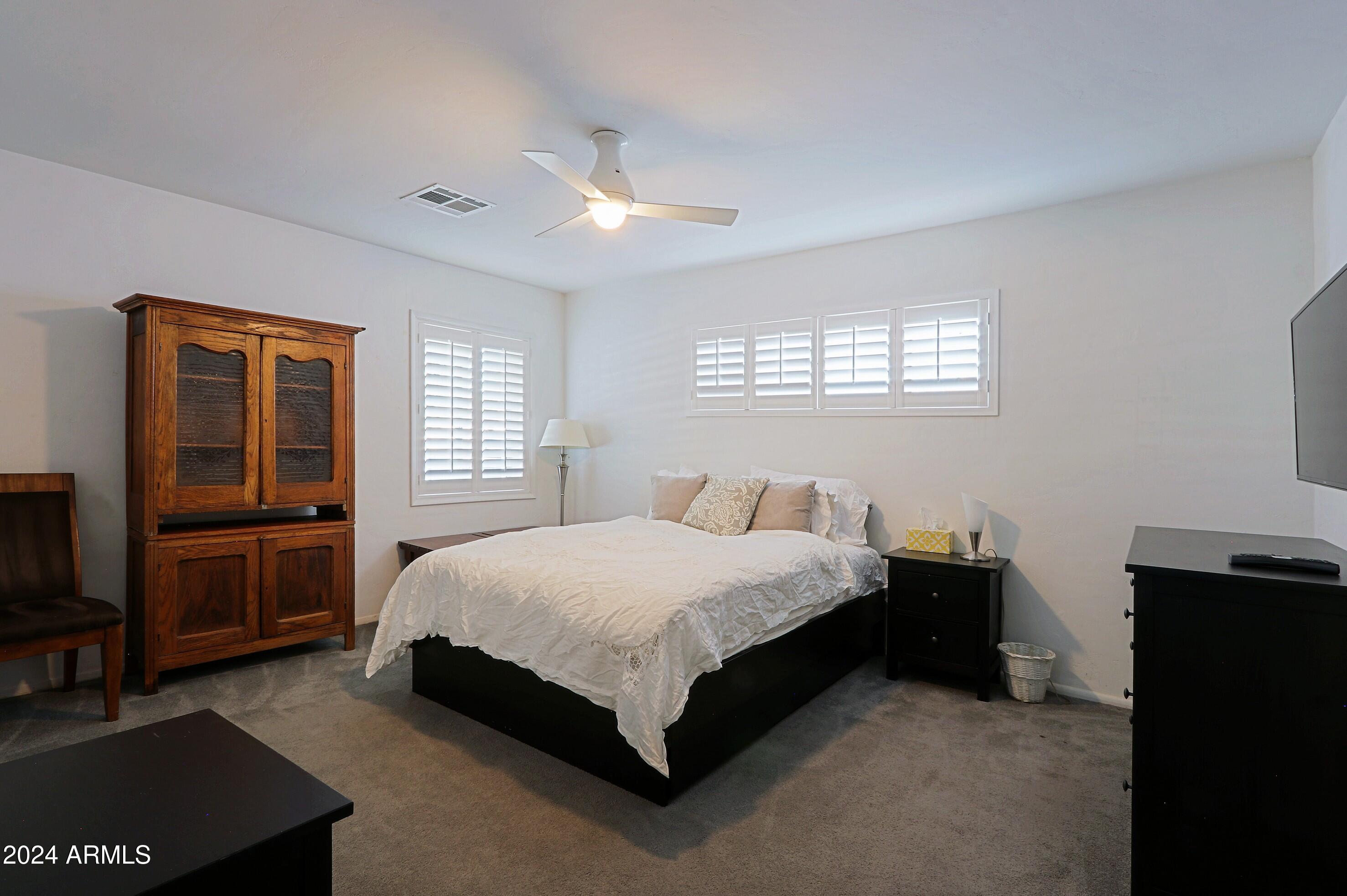 4645 East Windsor Avenue Phoenix, AZ 85008 - Photo 21 of 33 a bedroom with a bed and wooden floor