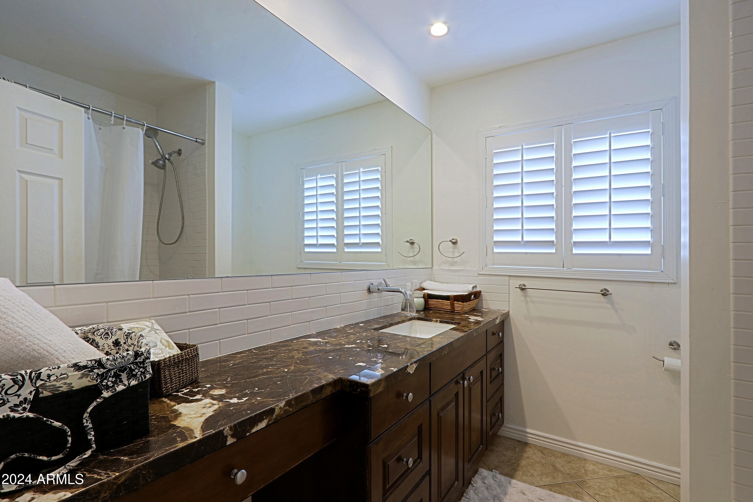 4645 East Windsor Avenue Phoenix, AZ 85008 - Photo 23 of 33 a kitchen with a sink stove and cabinets