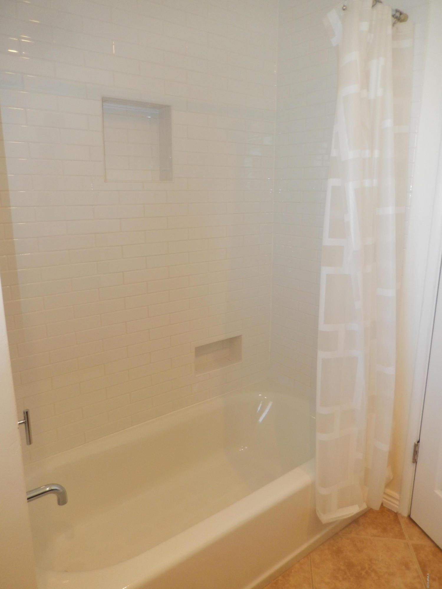 4645 East Windsor Avenue Phoenix, AZ 85008 - Photo 24 of 33 a close up of a bathtub with a shower
