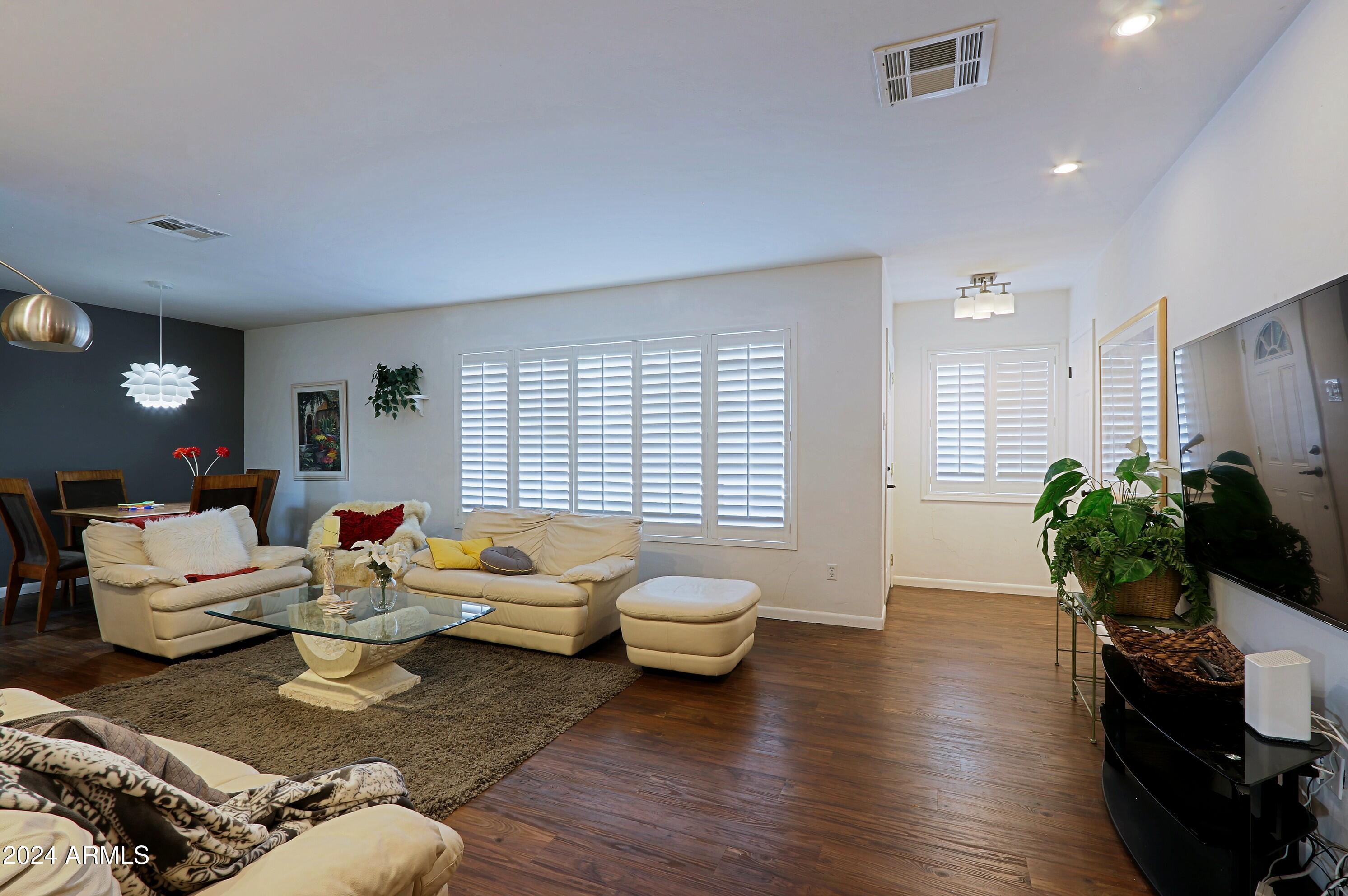 4645 East Windsor Avenue Phoenix, AZ 85008 - Photo 3 of 33 a living room with furniture and wooden floor