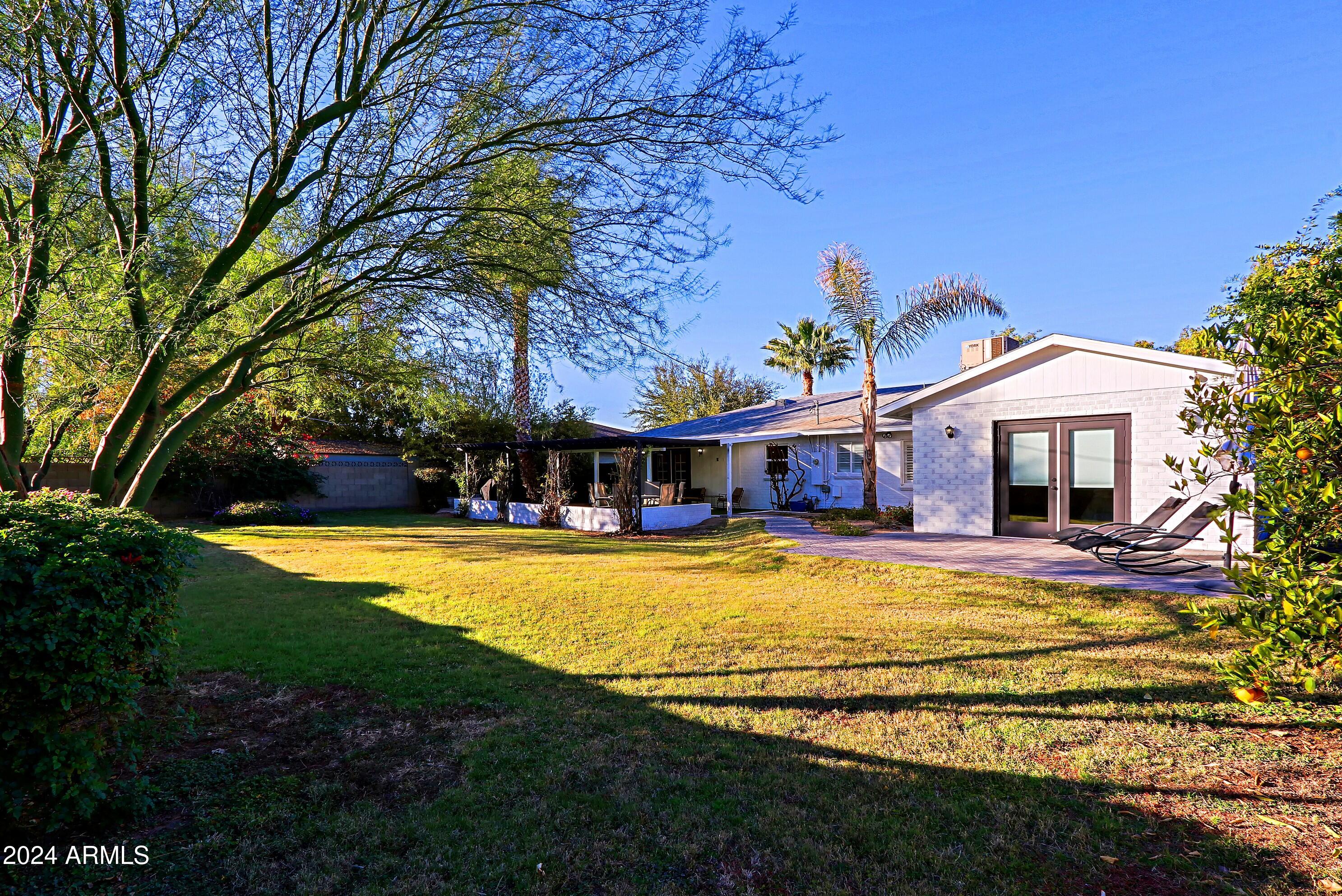 4645 East Windsor Avenue Phoenix, AZ 85008 - Photo 31 of 33 a view of a house with swimming pool and a yard