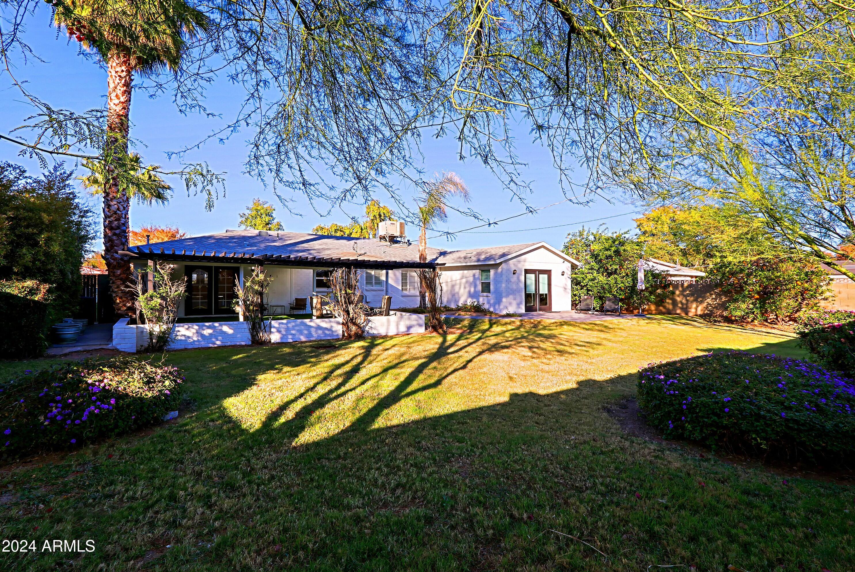 4645 East Windsor Avenue Phoenix, AZ 85008 - Photo 32 of 33 a view of swimming pool with a table and chairs under an umbrella