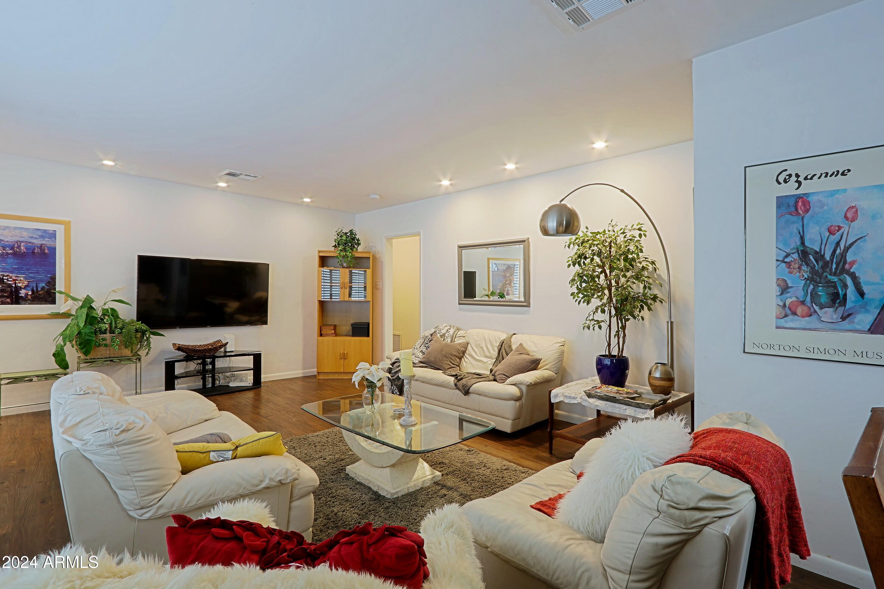 4645 East Windsor Avenue Phoenix, AZ 85008 - Photo 5 of 33 a living room with furniture and a flat screen tv