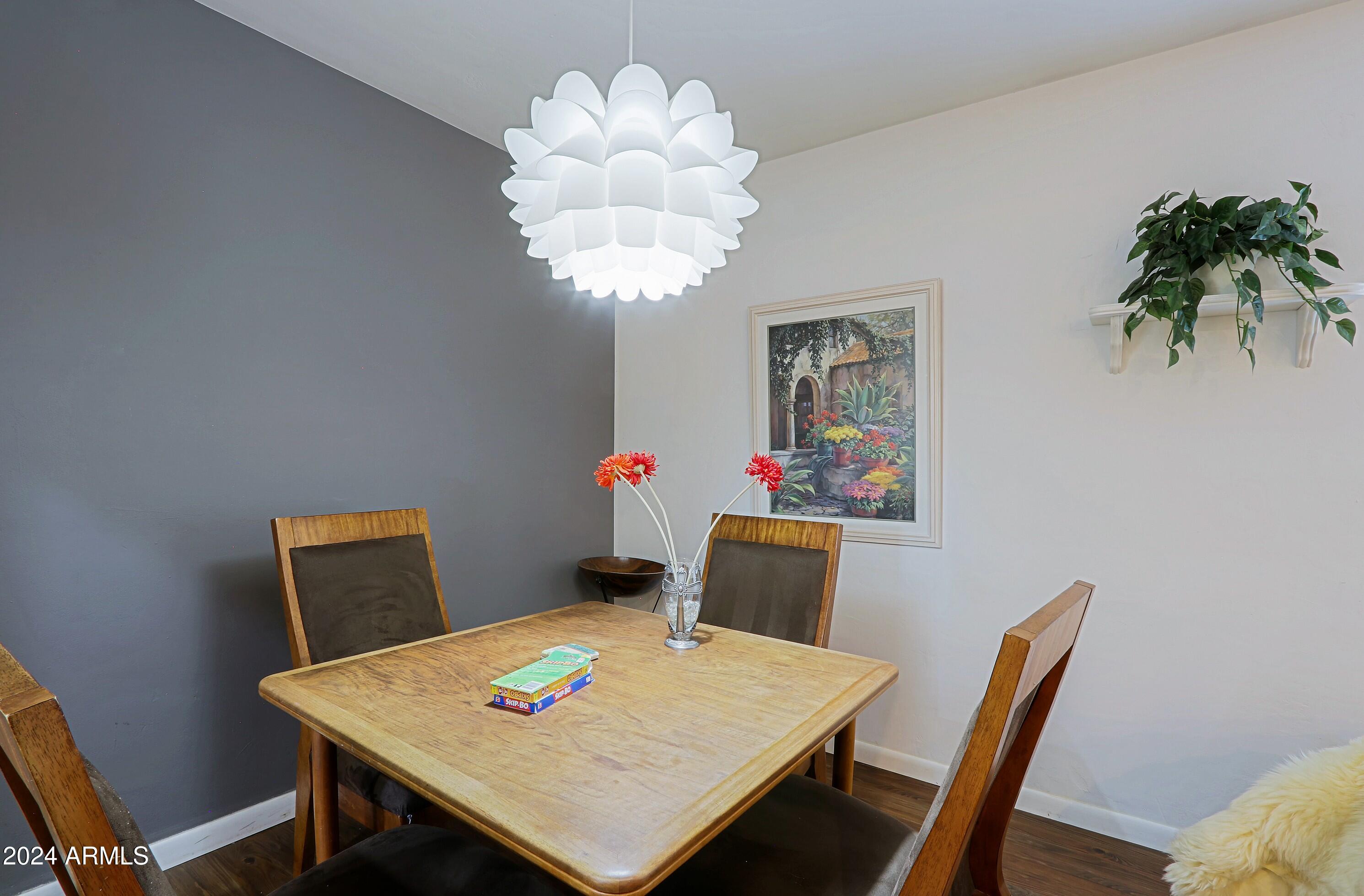 4645 East Windsor Avenue Phoenix, AZ 85008 - Photo 7 of 33 a view of a dining room with furniture and wooden floor