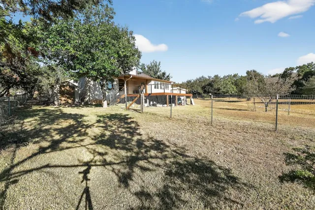 a view of a yard with a tree