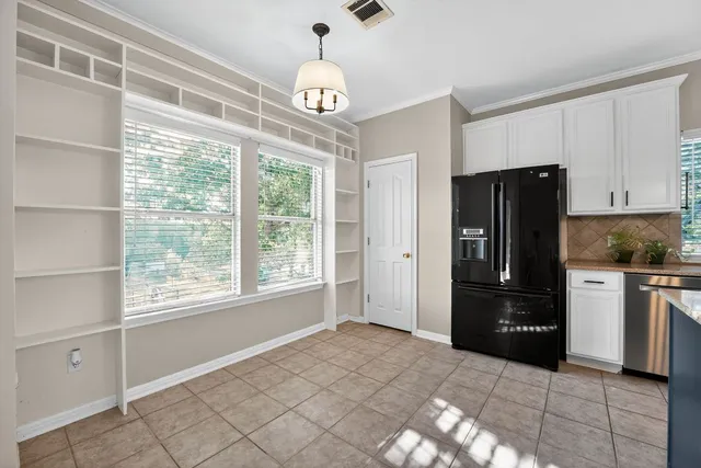 a kitchen with a refrigerator a stove top oven and kitchen island