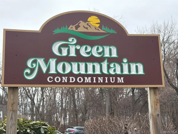 a street sign that is on the wall of building