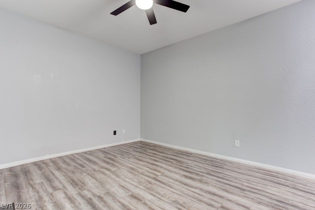 7724 Vibrant Thread Court Las Vegas, NV 89149 - Photo 5 of 43 Well-lit room offering neutral tones and durable wood-look flooring.