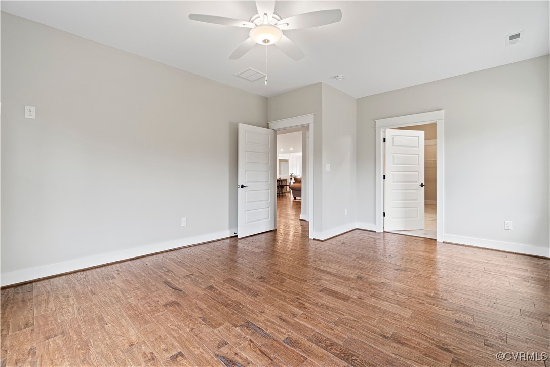 Lot 44 Wendenburg Circle, Unit SPEC Aylett, VA 23009 - Photo 13 of 19 an empty room with wooden floor and ceiling fan