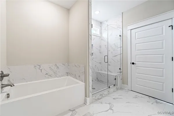 a bathroom with a bathtub and shower